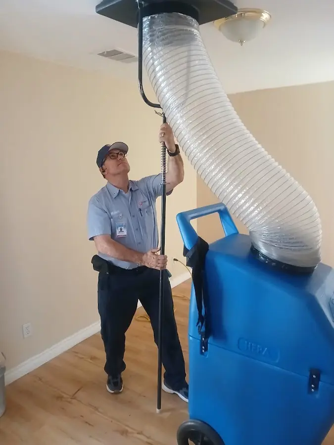 Furnace Tune-Up technician using HEPA equipment in Red Oak