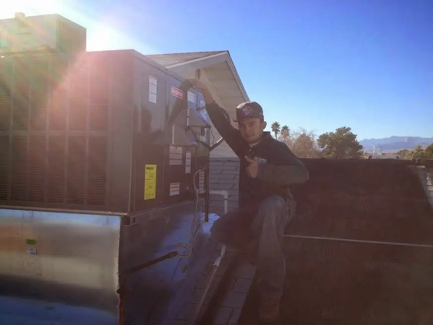HVAC technician performing HVAC Inspection on a rooftop unit in Red Oak